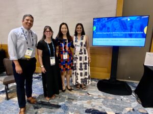 Simón Miera and Nancy Bromberger of TalkingPoints standing with Sophia Charchuk of Seattle Public Schools and Raj Rai of San Juan Unified School District (CA) during their presentation session at NSPRA